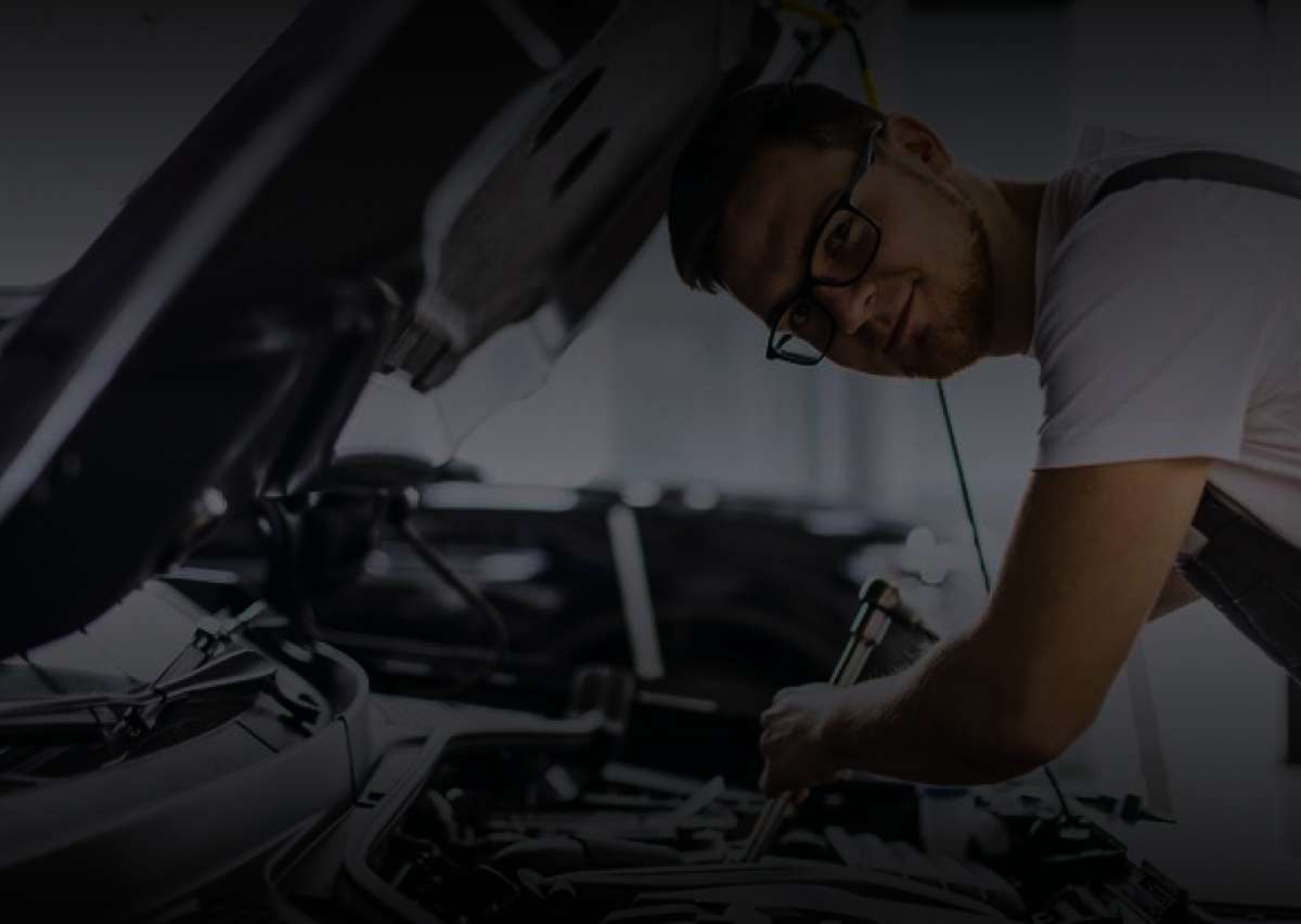 Technician servicing a car